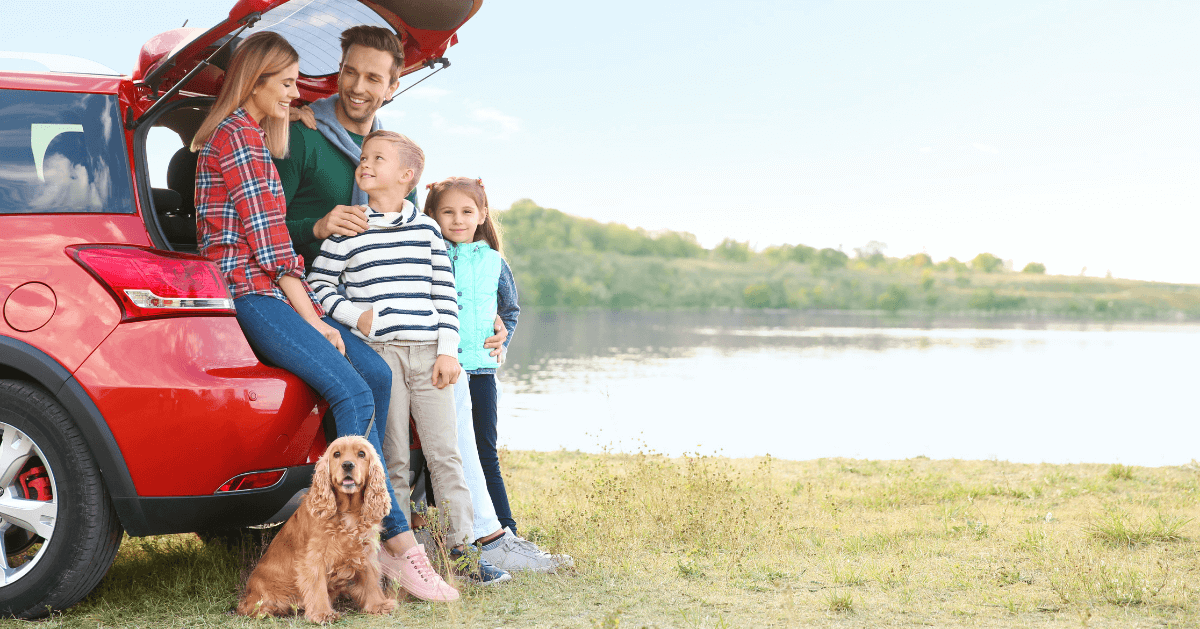 dog with family outside the car